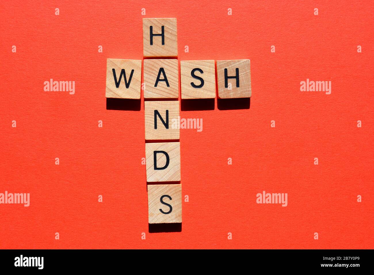Wash Hands, words in 3d wooden alphabet letters on red background Stock Photo