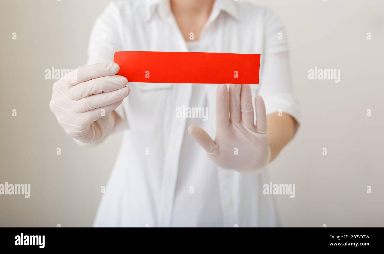 Doctor in a hospital holding a red warning sign mock up for your text. Doctor show stop hands gesture for stop virus or disease. Doctor hands in white Stock Photo