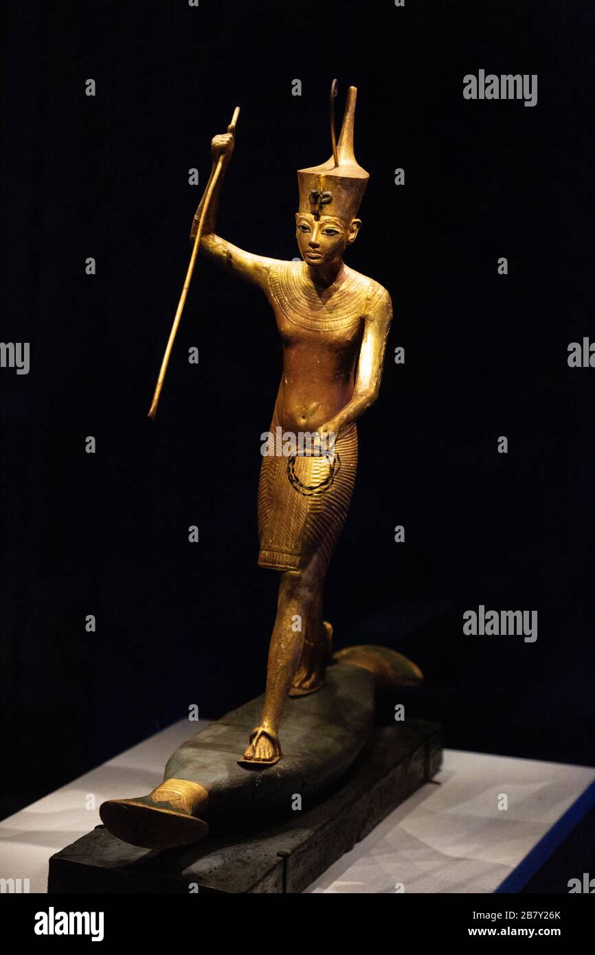 Tutankhamun statue; Gilded wooden statue of Tutankhamun standing on a skiff; Treasures from Tutankhamuns tomb- Ancient Egyptian treasures. Stock Photo