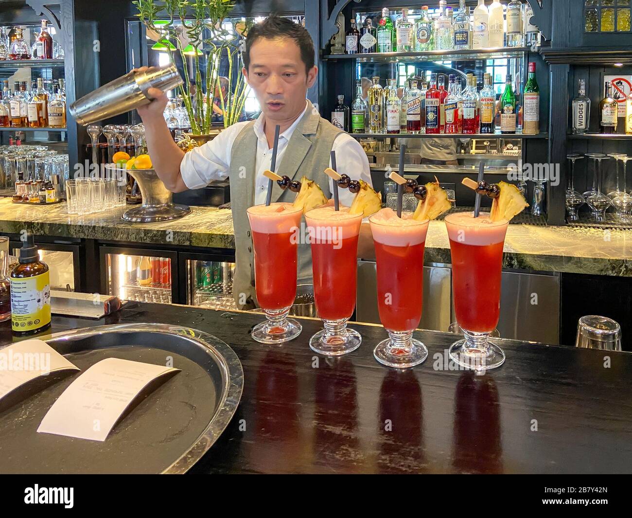 Singapore Sling cocktails in The Long Bar at Raffles Hotel Singapore, Beach Road, Singapore Island, Singapore Stock Photo