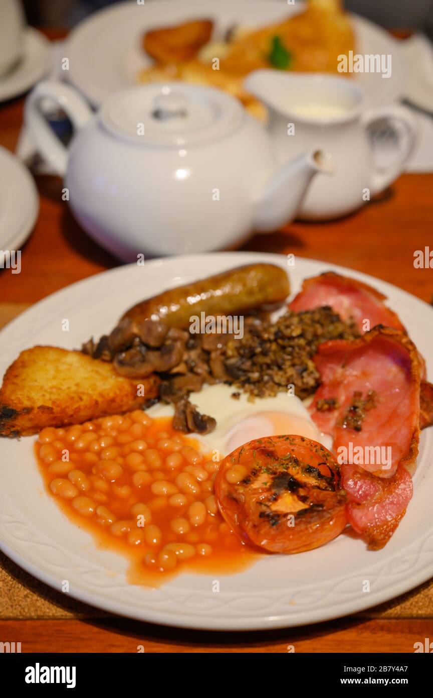 White board with full Scottish breakfast with bacon, fried egg, beans