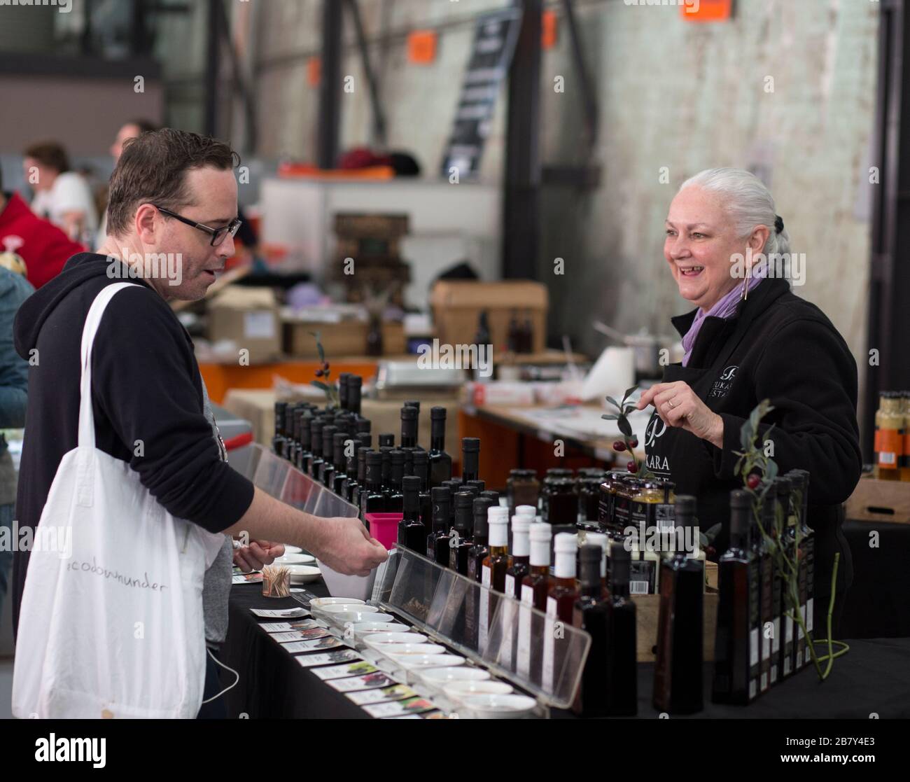 Shopper and vendor at Carriageworks Farmers Market, Sydney Stock Photo