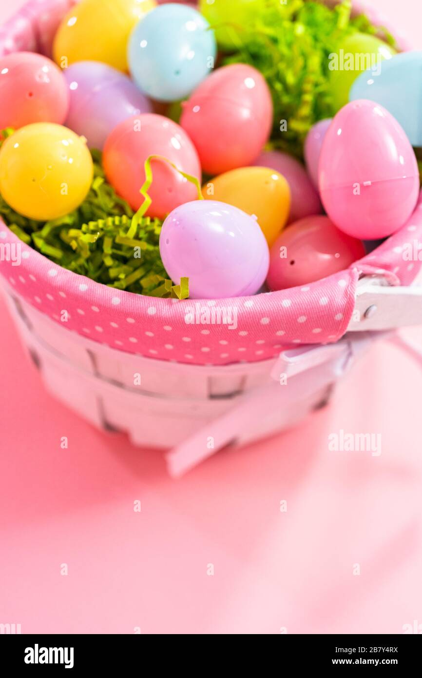 Easter basket with easter eggs on a pink background Stock Photo - Alamy