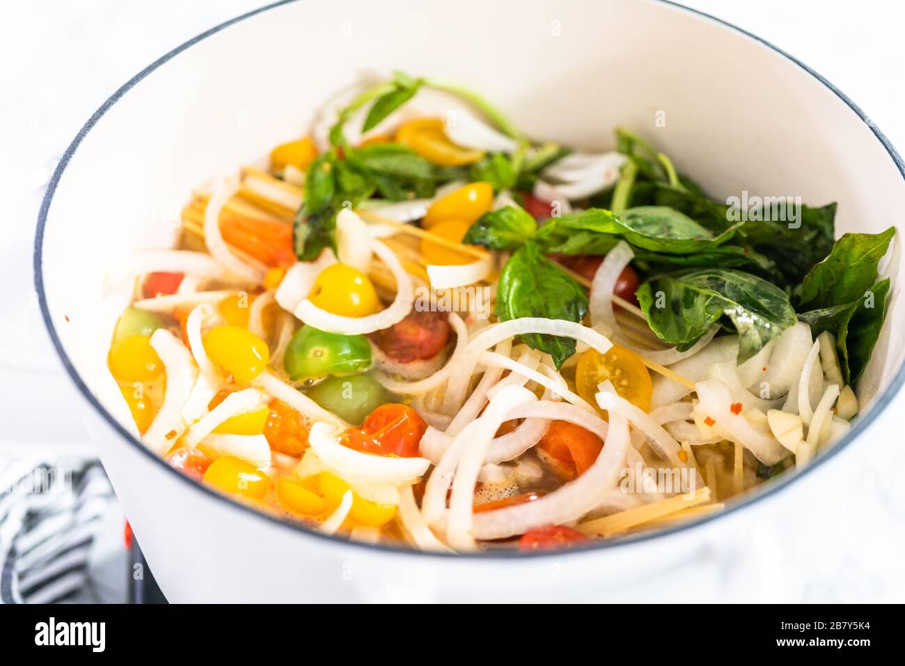 Preparing one pot pasta in enameled cast iron dutch oven Stock Photo Alamy