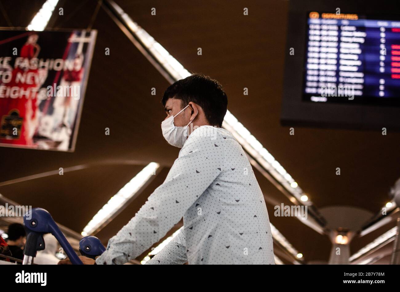 Kuala Lumpur, Malaysia - 18. March 2020: Travelers wearing face mask during COVID-19 pandemic at the international airport. Stock Photo