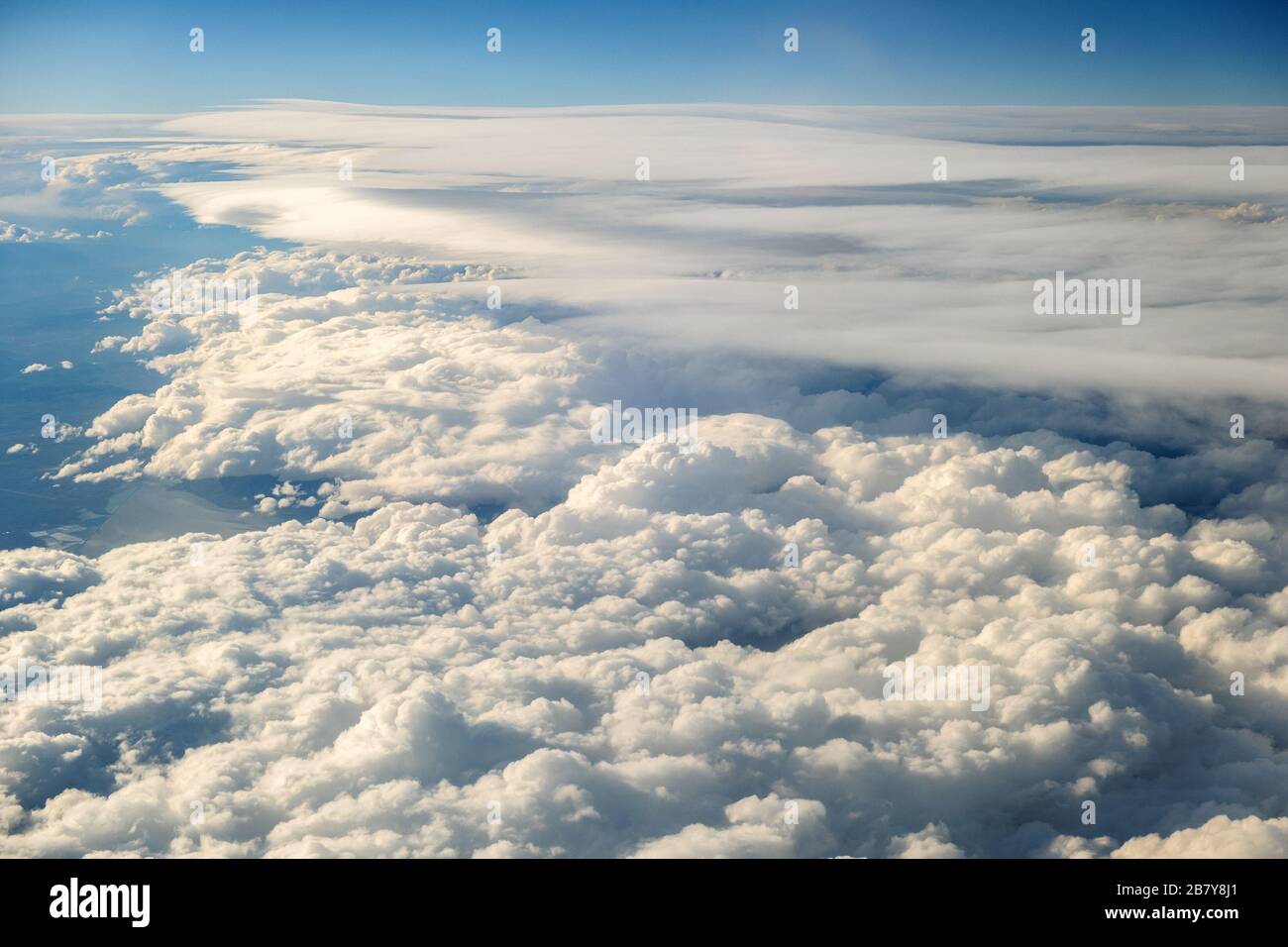 Aerial view of white puffy clouds viewed from an airplane Stock Photo ...