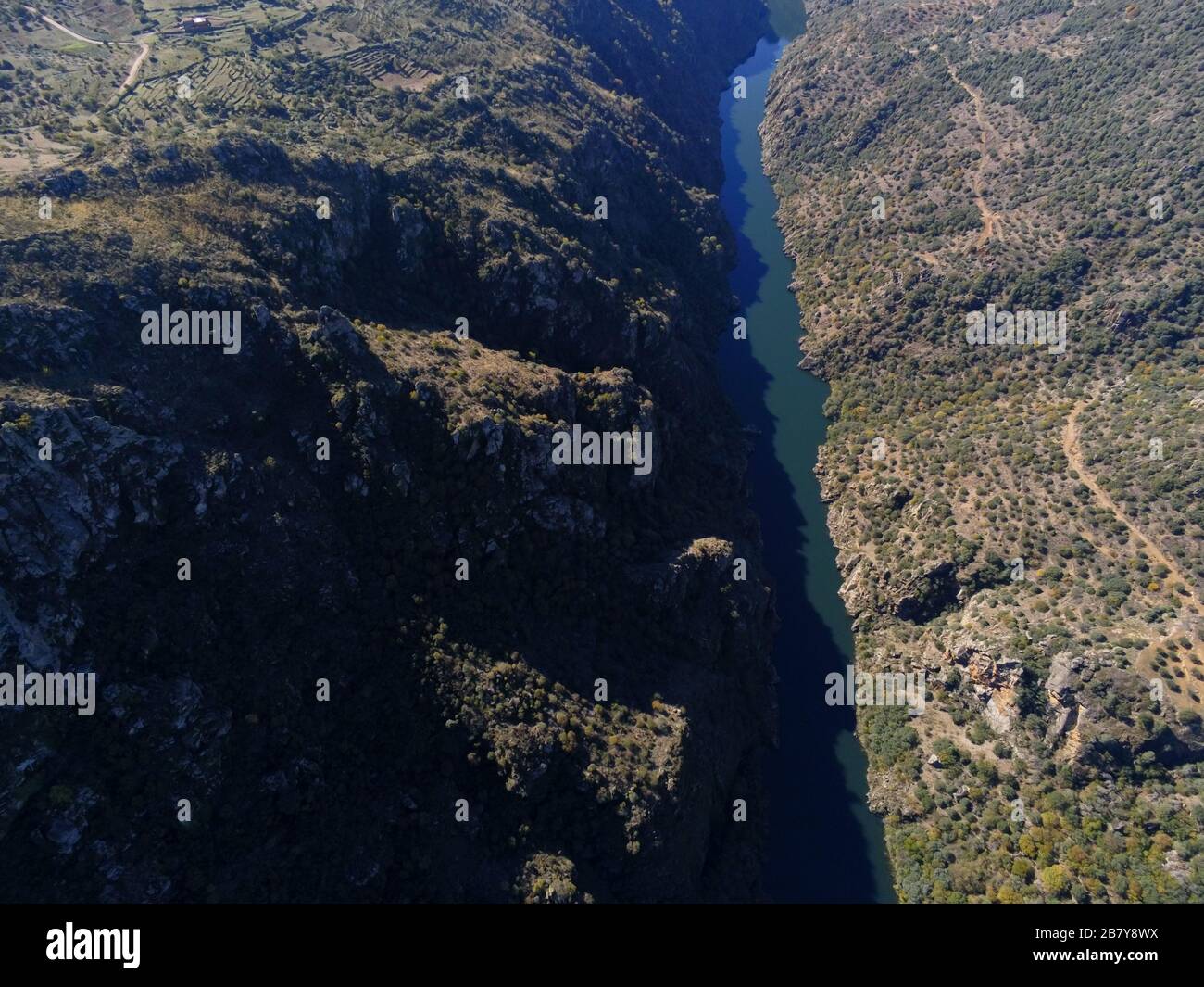 Aerial shot of a river in the middle of mountains in Pereña de la Ribera. Salamanca, Spain Stock Photo