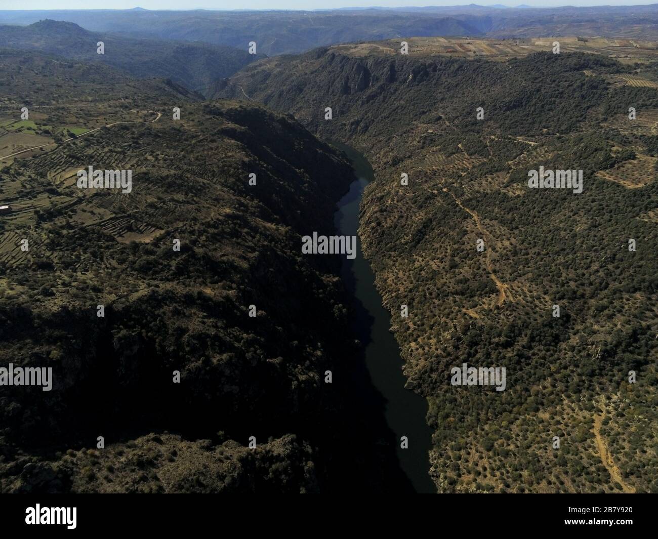 Aerial shot of a river in the middle of mountains in Pereña de la Ribera. Salamanca, Spain Stock Photo