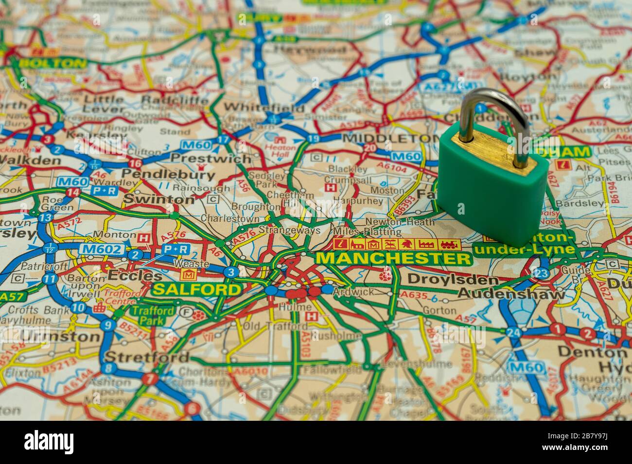 Manchester UK Shown on a road map or geography map with a padlock on top to represent a city in lock down Stock Photo