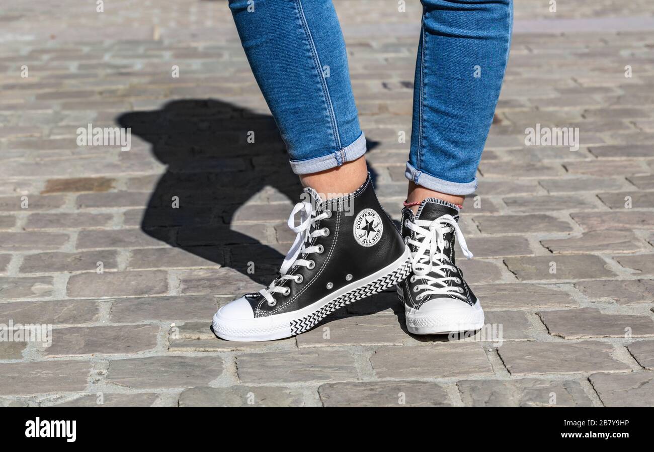 Chartres, France - Spetember 2, 2019: of the lower part of in jeans and All Star Converse sneakers in a cobblestone street Stock Photo - Alamy