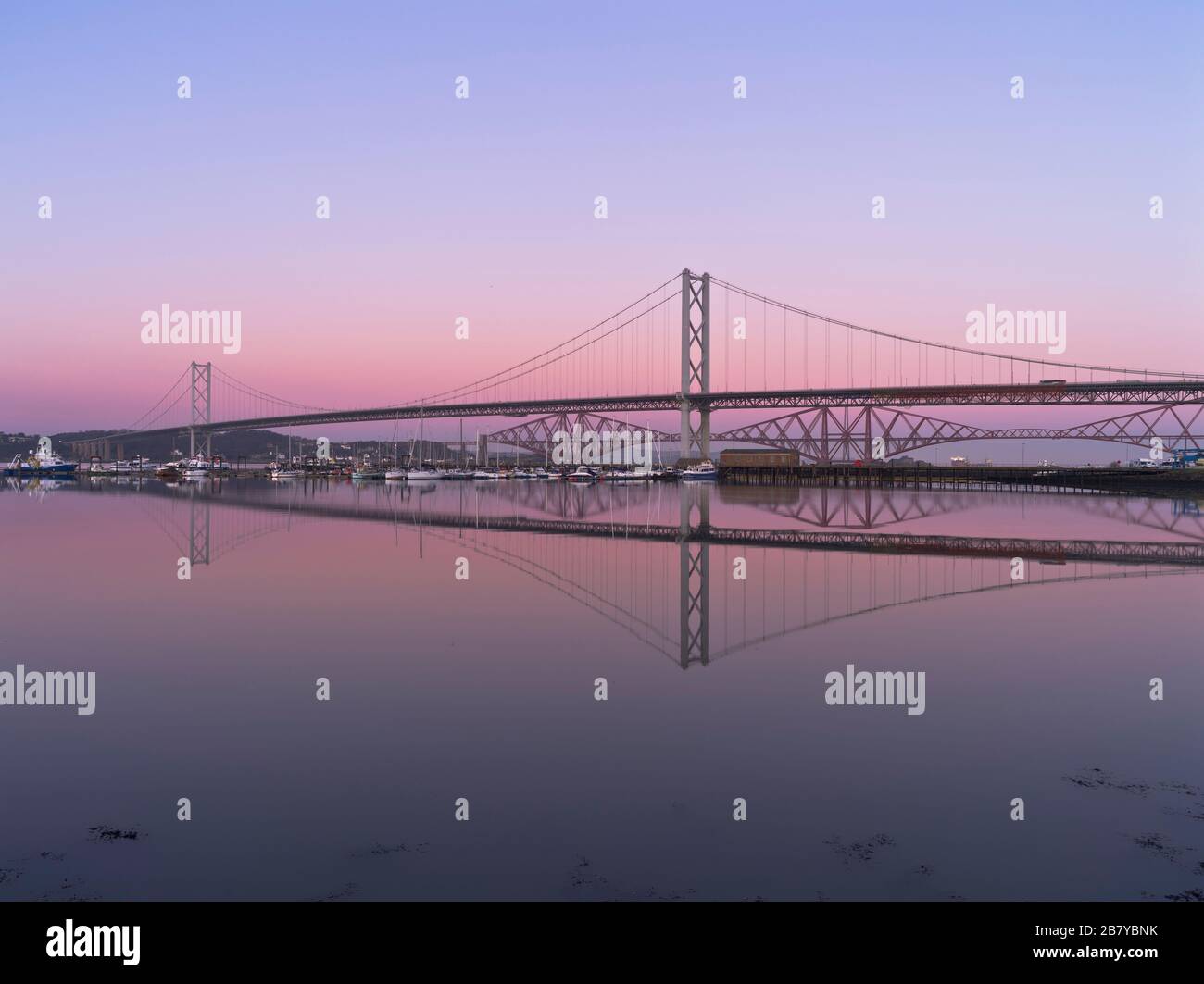 dh Scottish two bridges RIVER FORTH FORTH BRIDGE Across river Forth Scotland Rail Road Bridges dusk Stock Photo