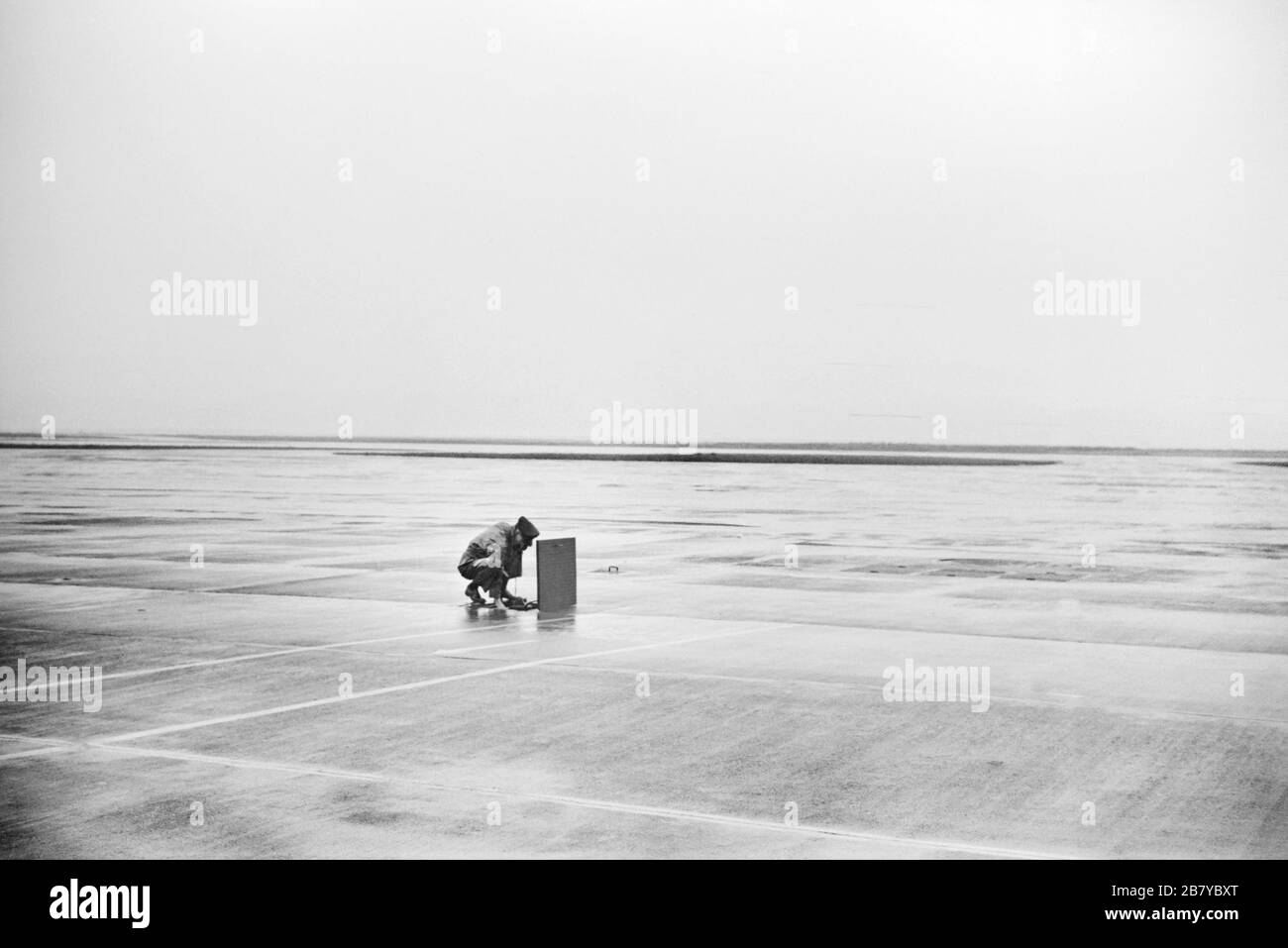 'Man using Telephone, which is part of Underground Communications System connecting Field with the Administration Building, Municipal Airport,, Washington, D.C., USA, Jack Delano for U.S. Office of War Information, July 1941 ' Stock Photo