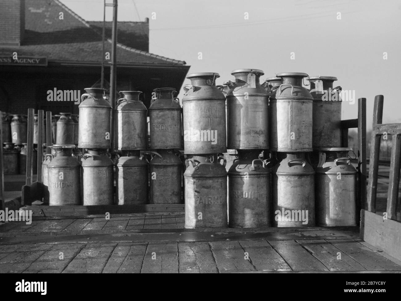 Milk cans at Railroad station. Minot, North Dakota, USA,  John Vachon for U.S. Farm Security Administration, October 1940 Stock Photo