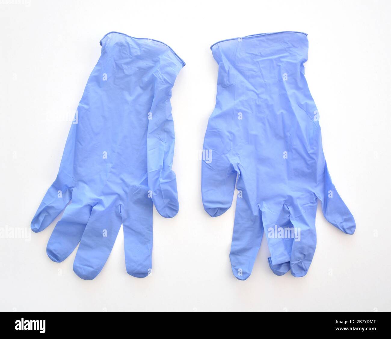 Disposable purple medical latex gloves on white background. Healthcare equipment concept Stock