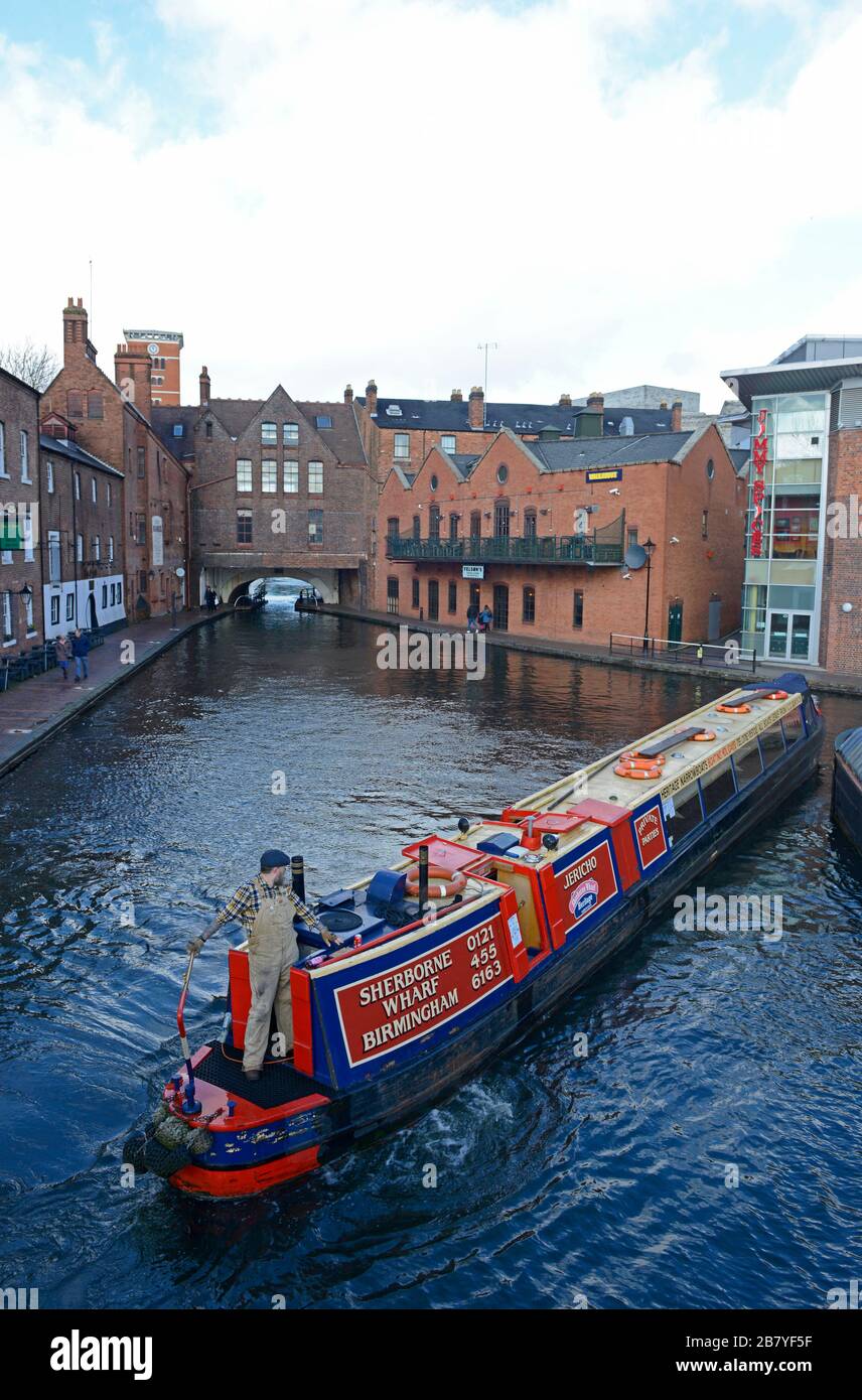 A canal boat is turned to go back the way it came in Gas Street Basin on Birmingham Canal Old Line, Birmingham, West Midlands, UK Stock Photo