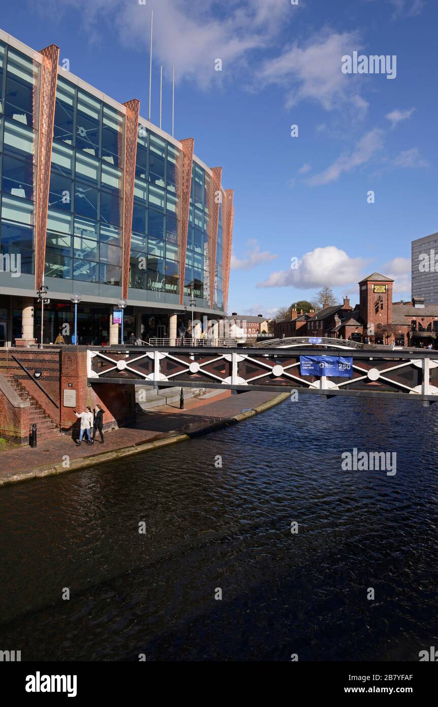 View of the canal with pedestrian footbridge at Old Turn Junction in central Birmingham, UK Stock Photo