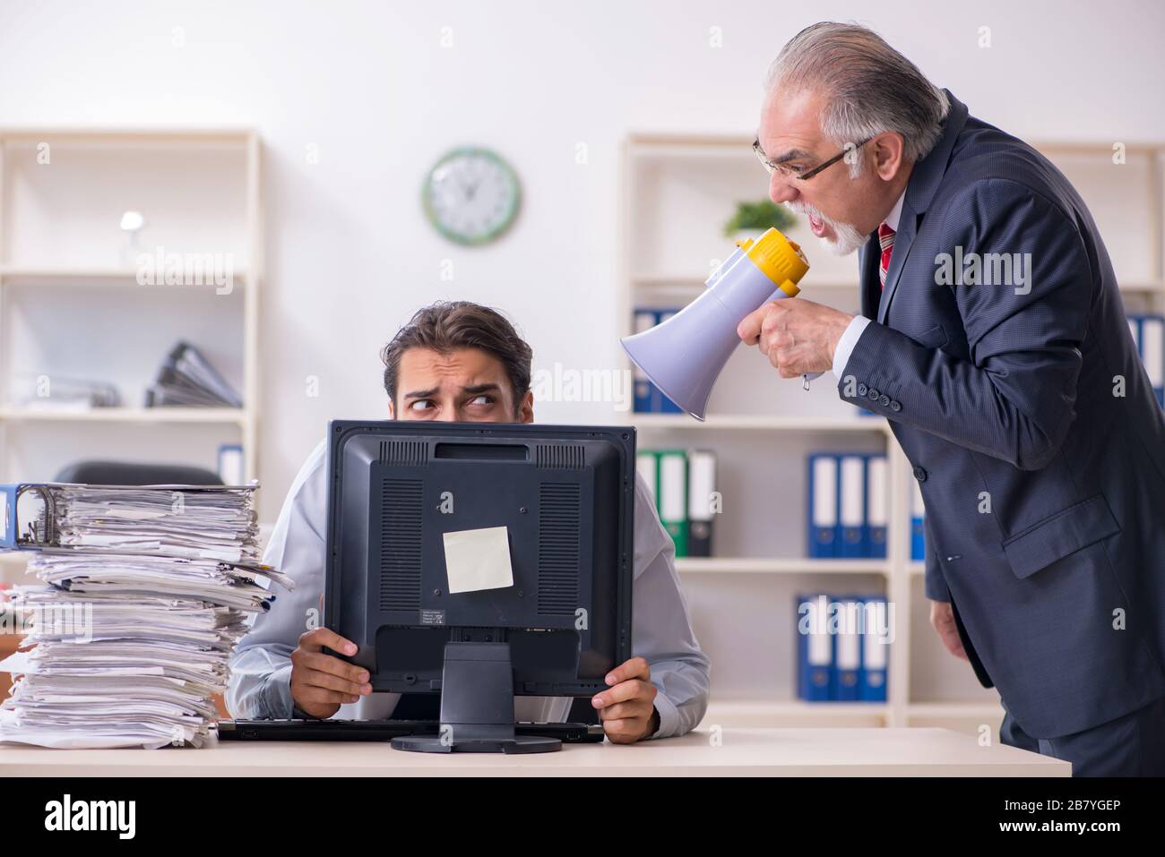 Old boss and young employee in the office Stock Photo Alamy