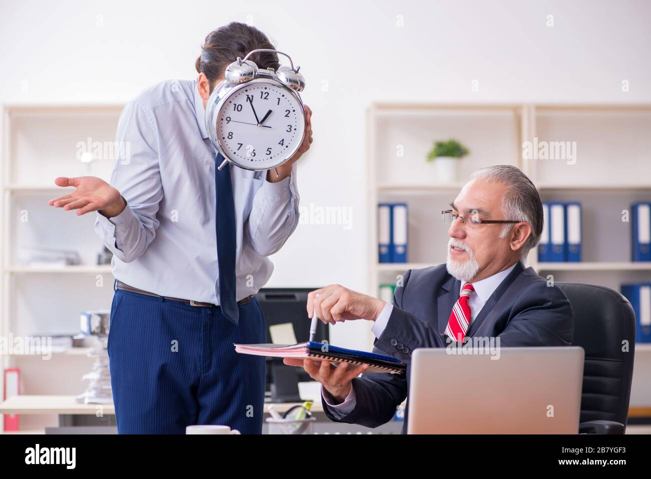 Old Boss And Young Employee In The Office Stock Photo - Alamy