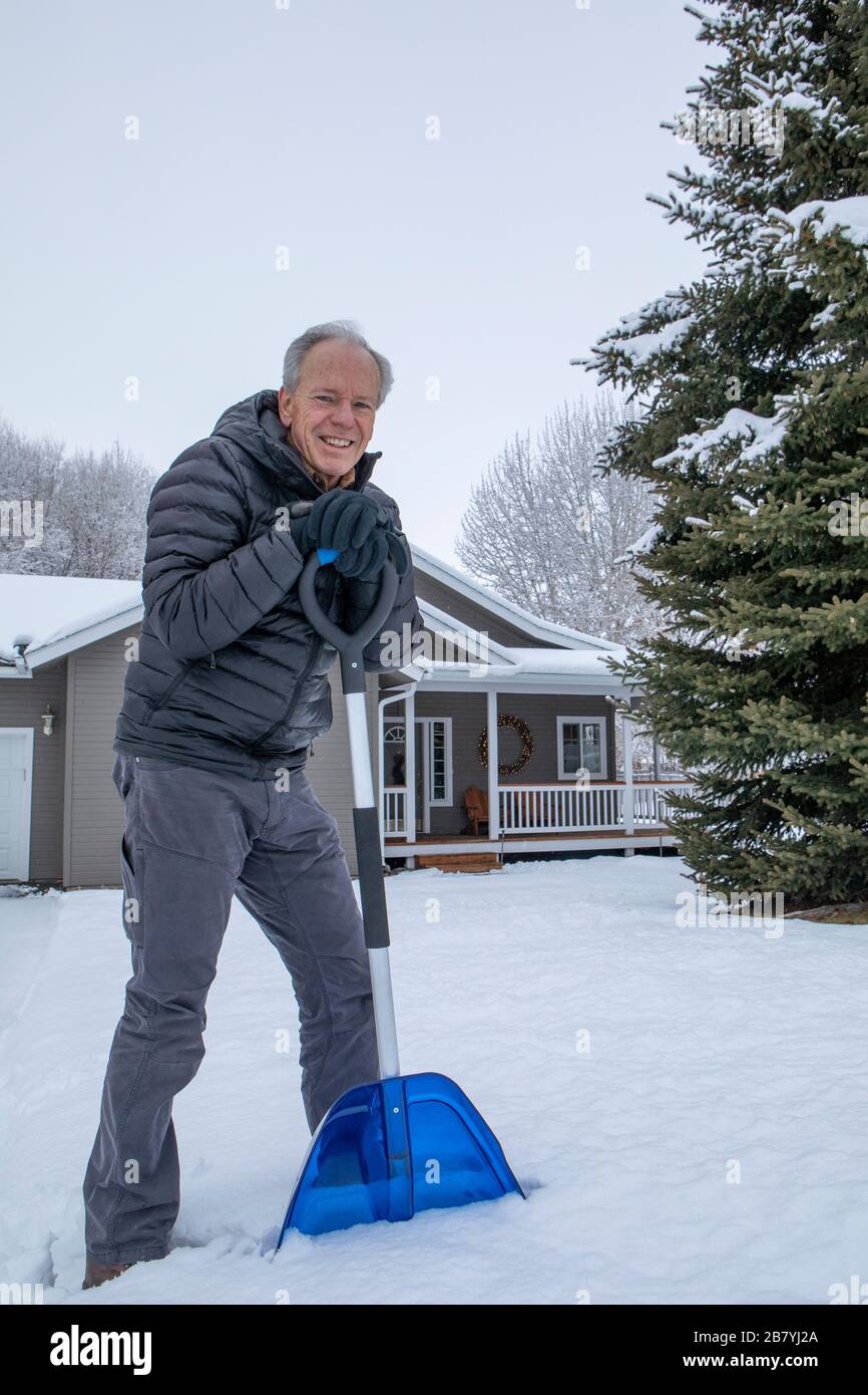 Senior man shoveling snow Stock Photo