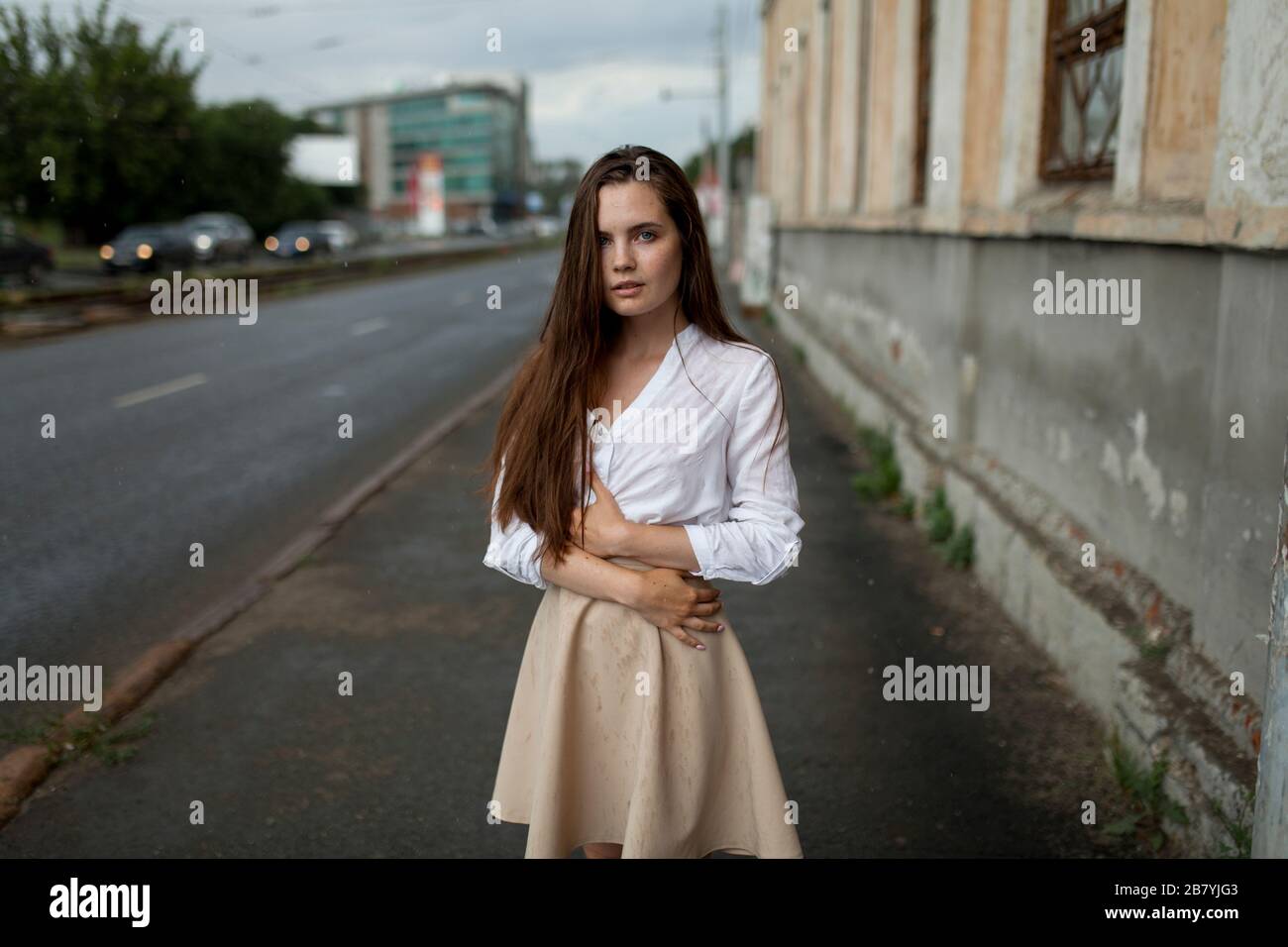 Young woman on city sidewalk Stock Photo