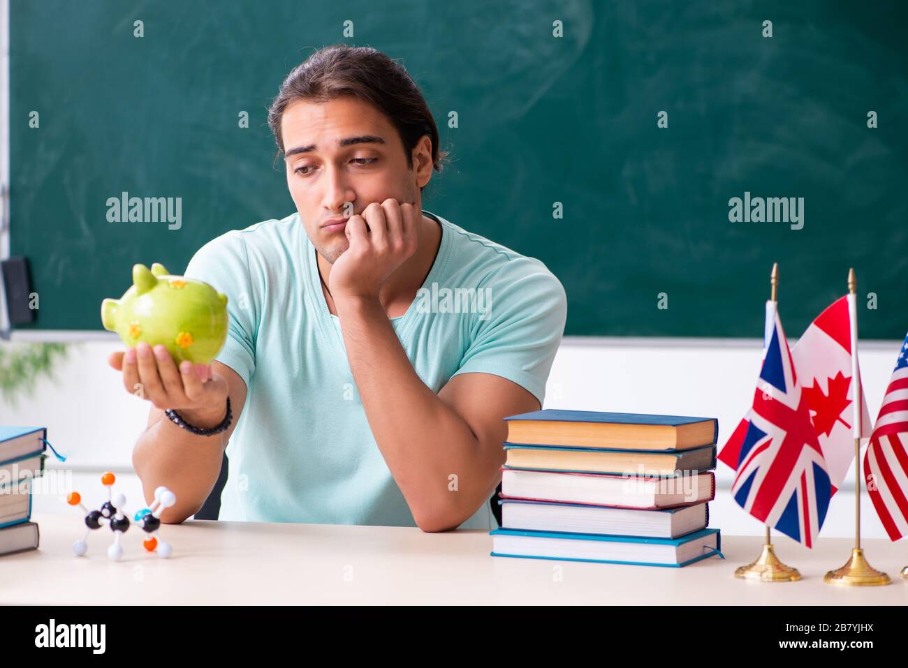 Young male student sitting in classroom Stock Photo - Alamy