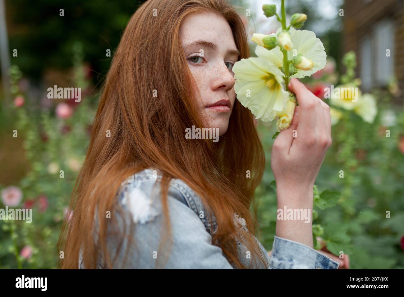 Teenage girl holding flower Stock Photo