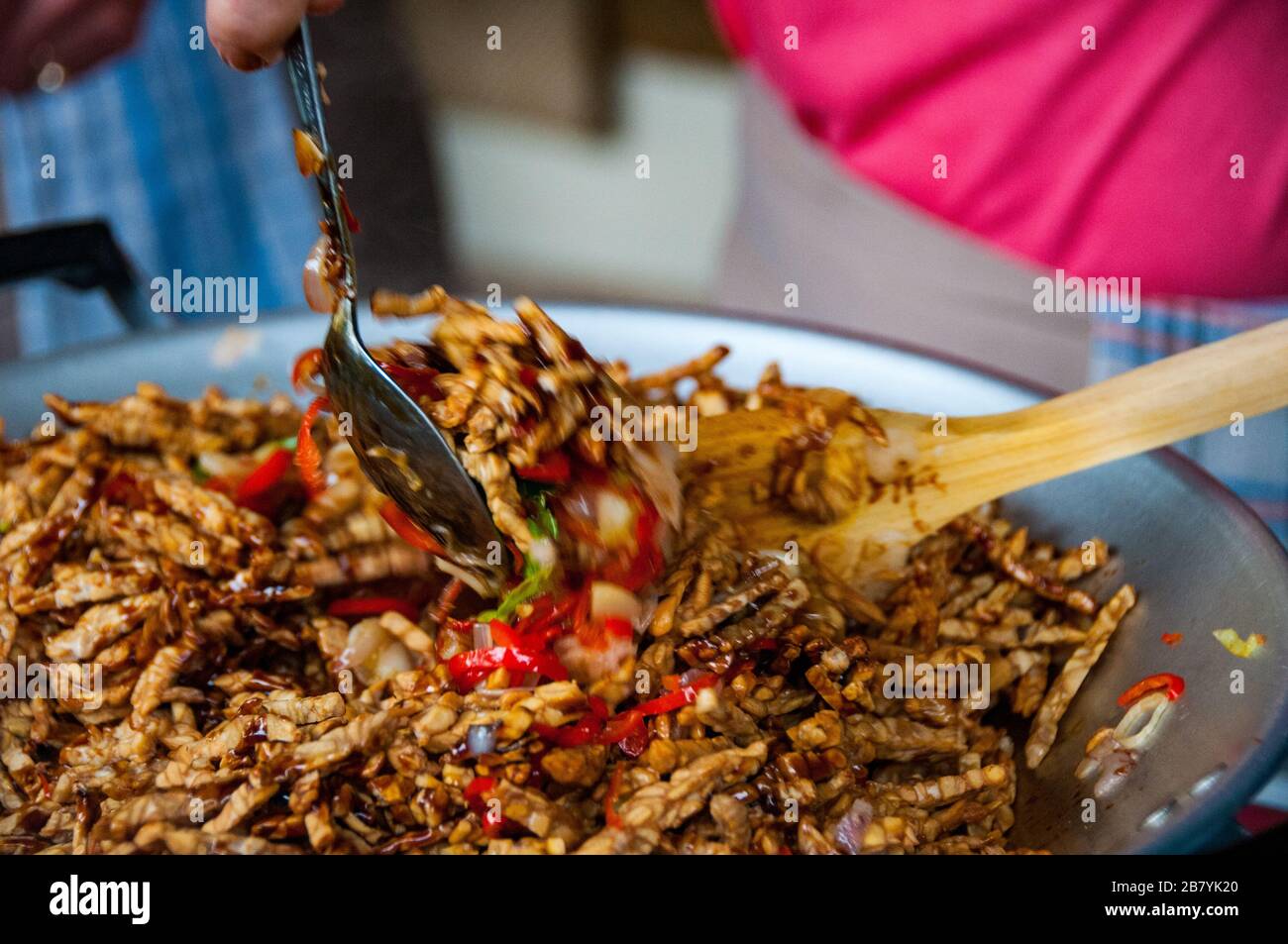 Deep fried tempe in sweet soy sauce (kecap manis) being cooked. Tempe