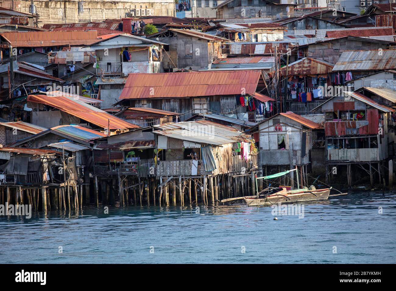 Poor district slums with wooden houses over water, Cebu city, Philippines. Stock Photo