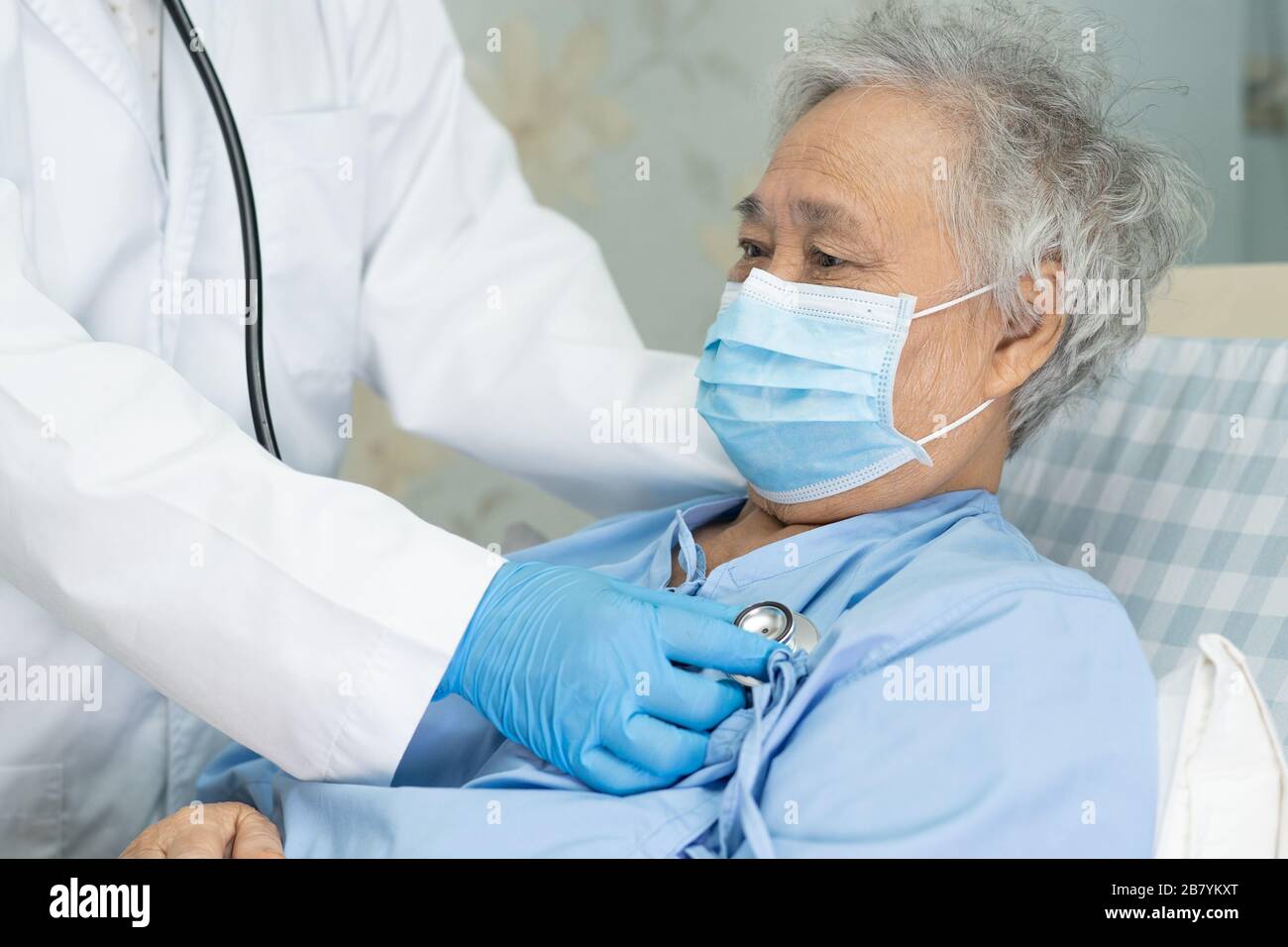 Asian senior or elderly old lady woman patient wearing a face mask in hospital for protect