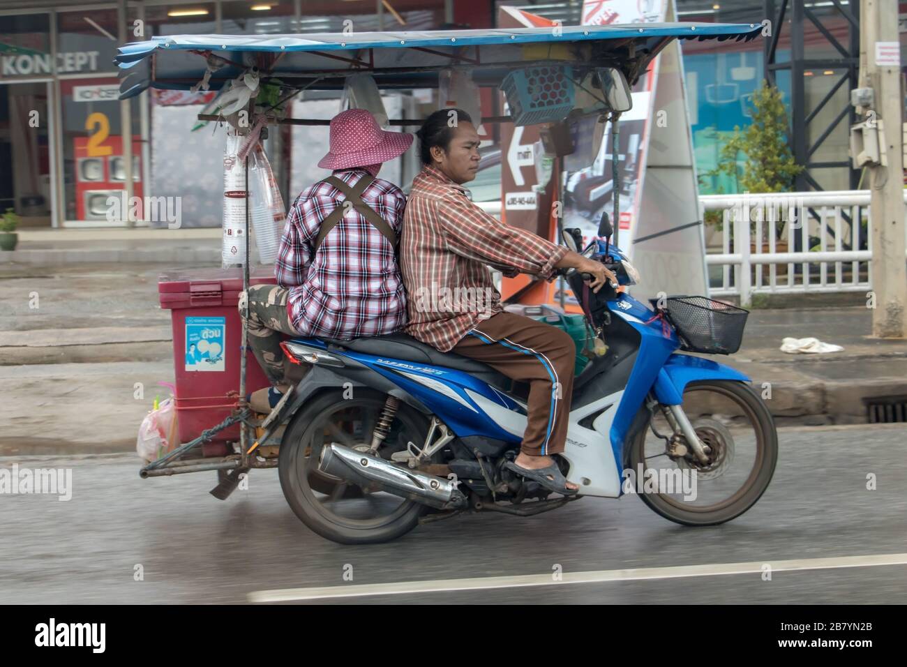 BANGKOK, THAILAND, SEP 21 2019, A couple rides a motorcycle with a cart ...