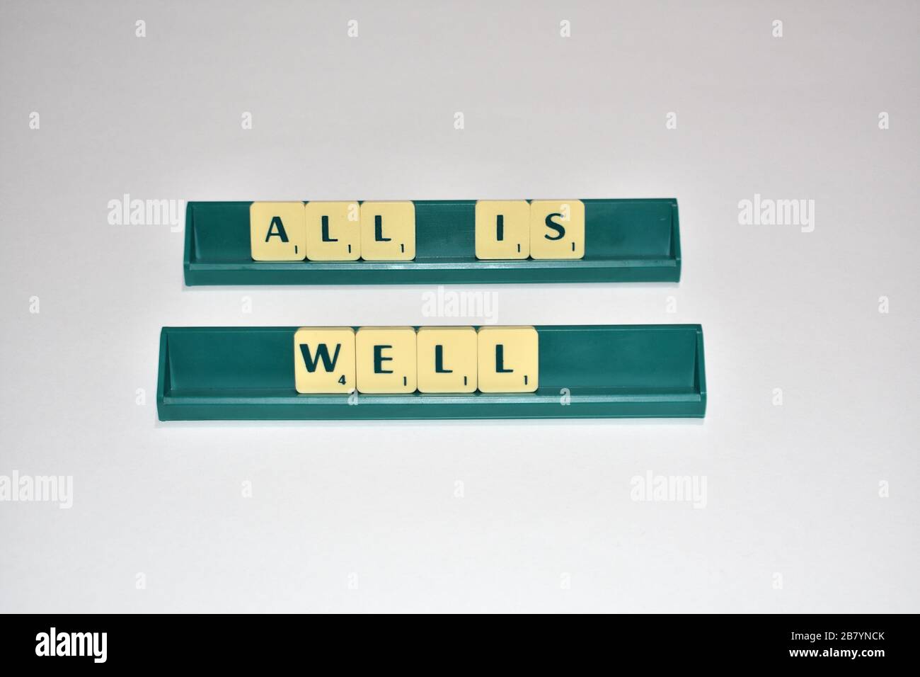 Scrabble tiles spell out Be Positive. Motivational quote Scrabble Blocks Letters Grey Background Life quote Induce Alphabet. Stock Photo