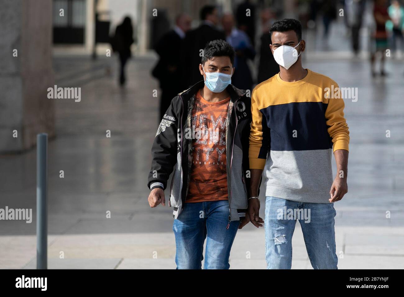 Lisbon Portugal 18th Mar 2020 Two Young Men Wearing Face Masks As A Precaution Against The Spread Of Coronavirus Walk Along Terreiro Do Paco Square In Lisbon Empty Streets Closed Commercial Spaces And