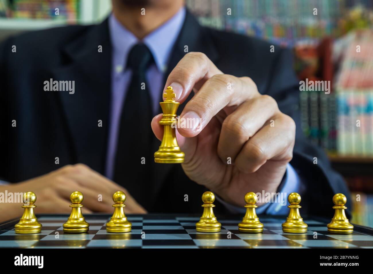 Chess game on chess board behind business man background. Business concept  to present financial information and marketing strategy analysis. Investmen  Stock Photo - Alamy