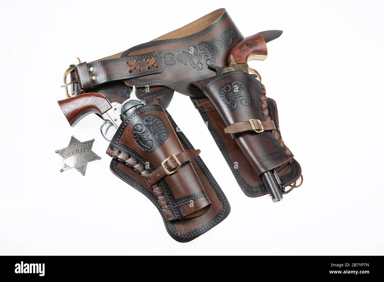 Leather cowboy holster and revolver on an isolated studio background