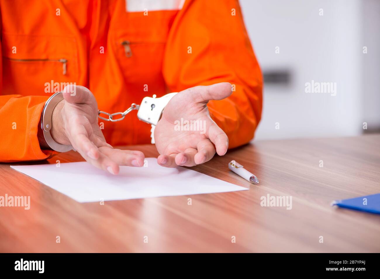 Young man writing letter in the provisional detention Stock Photo