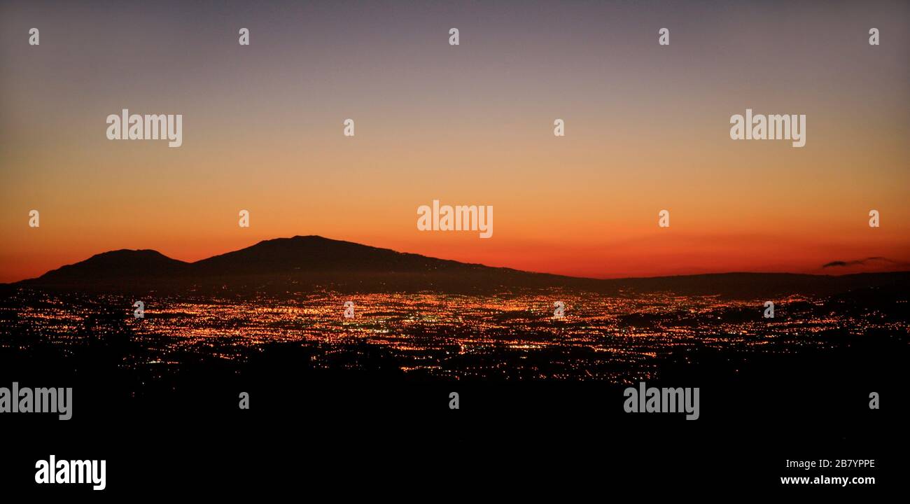 Sunrise over the city lights of San José and Irazú Volcano, Costa Rica. View from the west (San Ramón). Stock Photo
