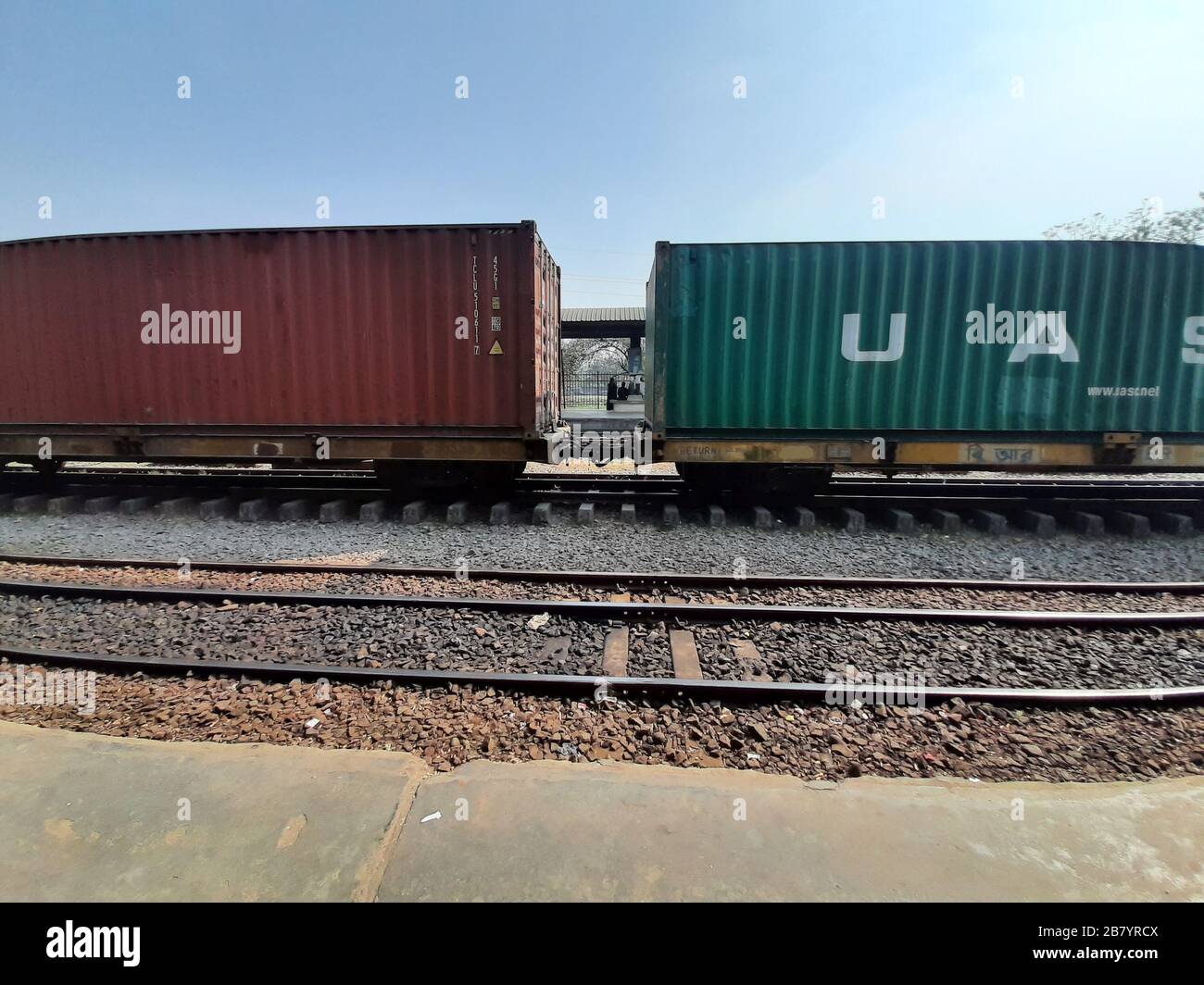 Shipping containers on container train in Dhaka, Bangladesh. The railway is the cheapest means of transportation in Bangladesh Stock Photo