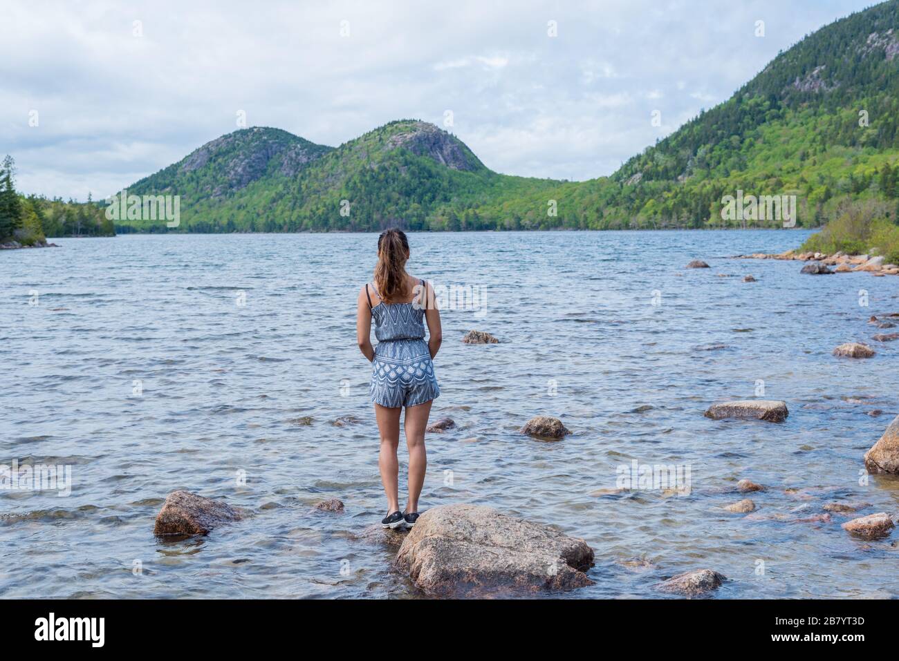 Woman enjoying the beautiful view of Jordan Pond in Acadia National Park Maine USA Stock Photo
