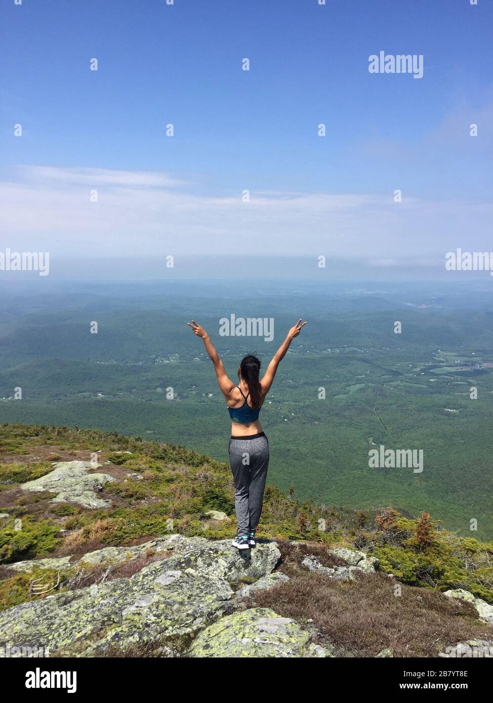 Woman enjoying the beautiful view of hills and mountains whilst hiking in Maine USA Stock Photo