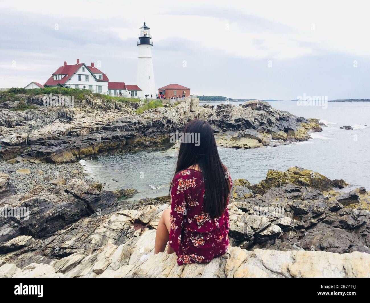 Woman enjoying beautiful view of Portland lighthouse in Portland Maine USA Stock Photo