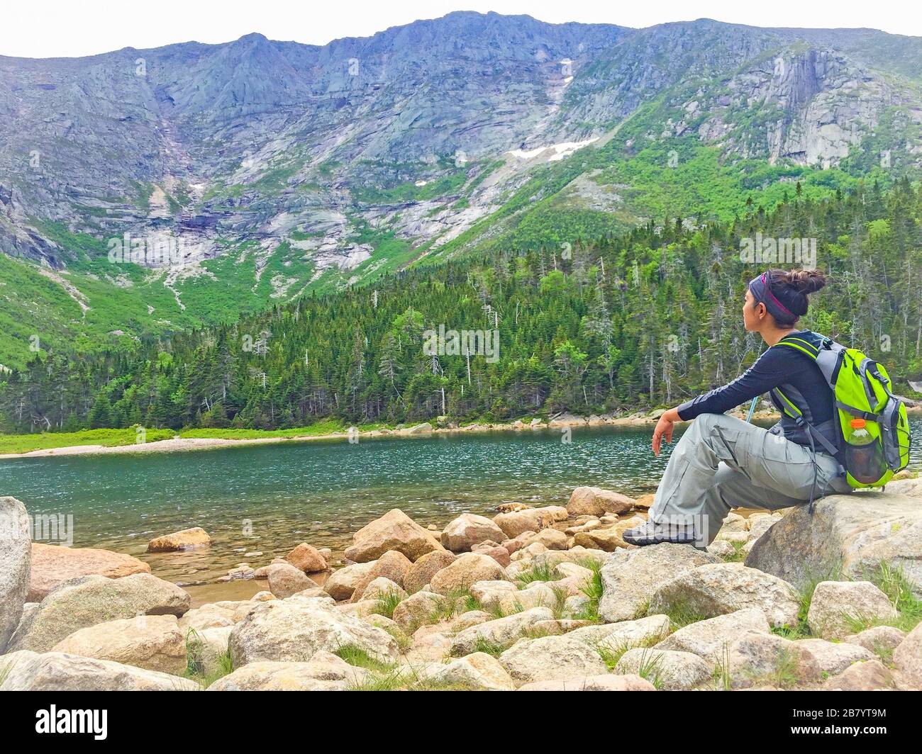 Woman enjoying the beautiful view of Jordan Pond in Acadia National Park in Maine USA Stock Photo
