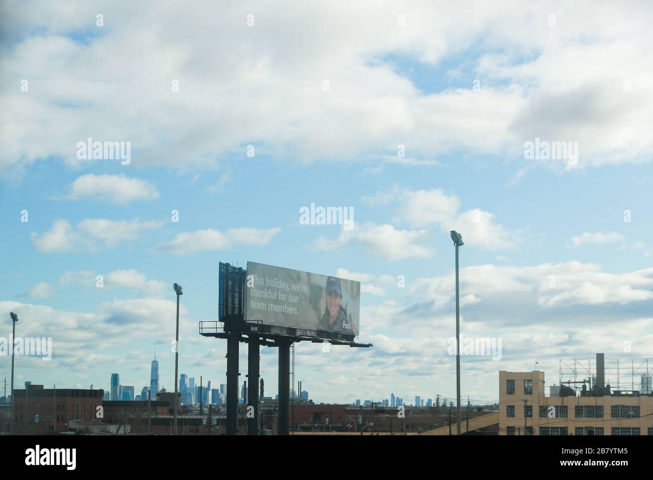 Secaucus, NJ / USA November 28, 2019: An advertisement billboard of FedEx on highway I-95 near New York City. FedEx Corporation is an American multina Stock Photo