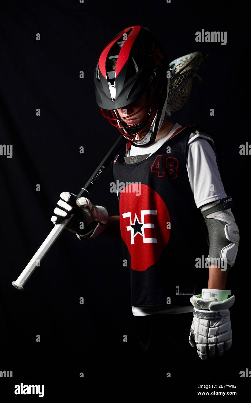 A teenage boy poses for portraits in his lacrosse uniform Stock Photo