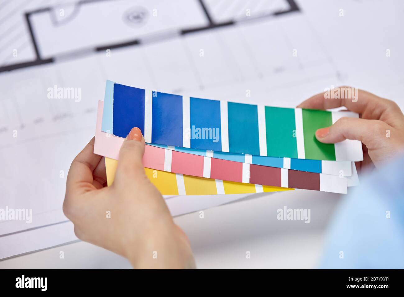 designer's hands with color palettes and blueprint Stock Photo - Alamy