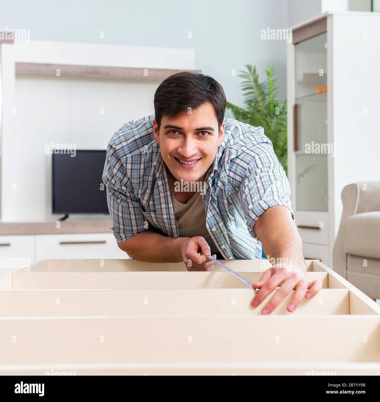 The man assembling furniture at home Stock Photo Alamy