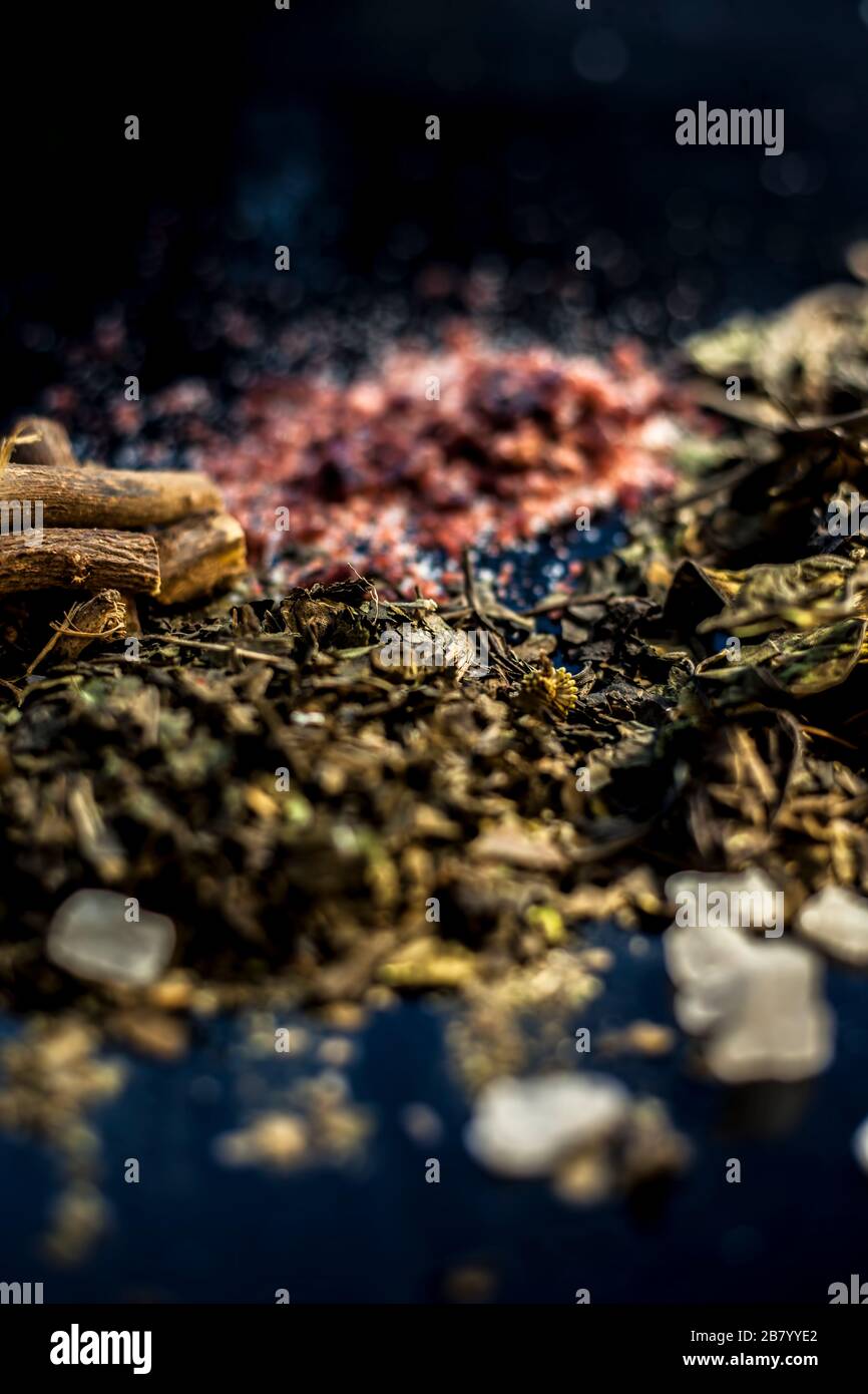 Best home ayurvedic remedy for ulcer i.e. Ardusi or Malabar nut, sugar, and mulethi or licorice. Shot of all the herbs on black surface with powder al Stock Photo