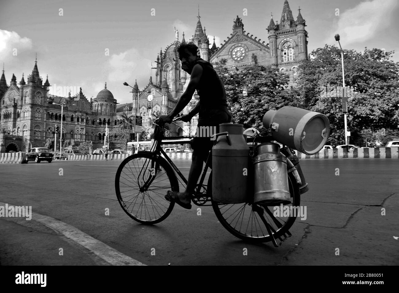 Milk vendor on bicycle, Victoria Terminus VT, Chhatrapati Shivaji Maharaj Terminus CST, UNESCO World Heritage Site, Bori Bunder, Bombay, Mumbai, India Stock Photo