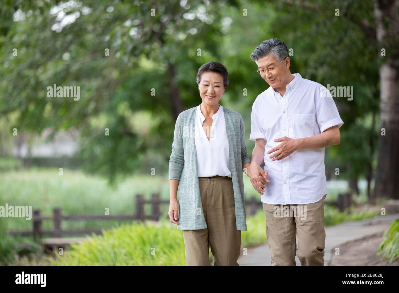 Happy senior chinese couple walking hi-res stock photography and images ...