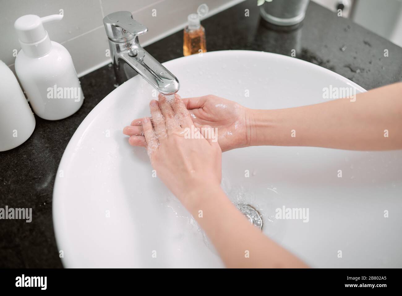 Washing hands with soap in bathroom, closeup Stock Photo Alamy