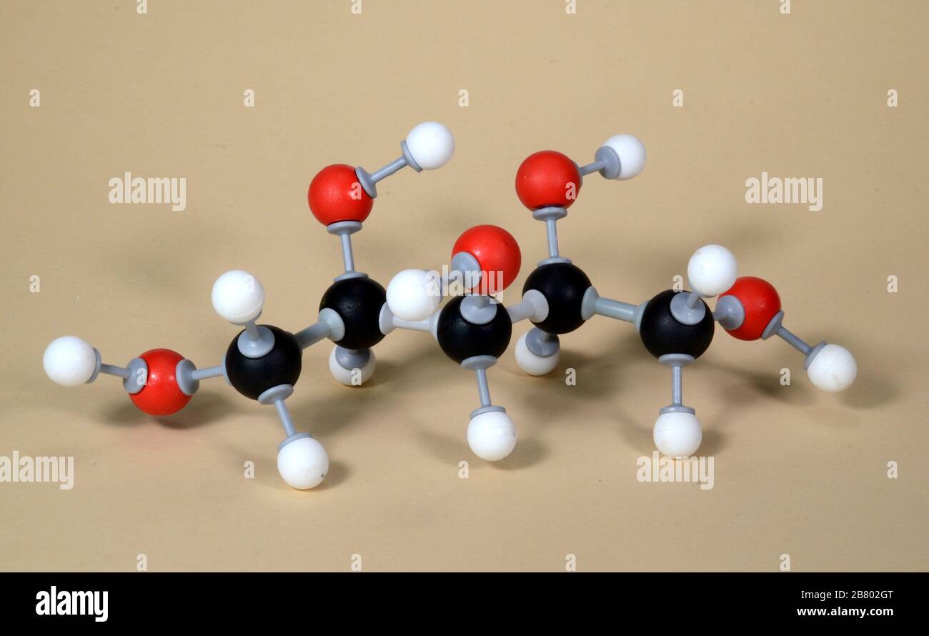 Molecule model of the sweetener Xylitol (E967). White is Hydrogen, black is Carbon, and red is Oxygen Stock Photo